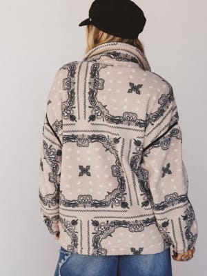 Person wearing a patterned jacket with a plain background