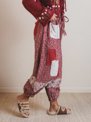 Person wearing a red and white patterned outfit with a plain background
