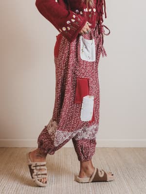 Person wearing a red and white patterned outfit with a plain background