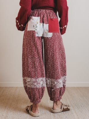 Person wearing a red patterned outfit with a white background