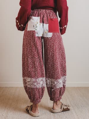 Person wearing a red patterned outfit with a white background
