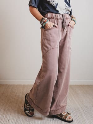 Person wearing wide-leg pants with a neutral background