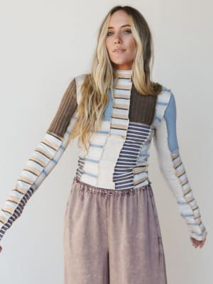 Woman wearing a patterned outfit with a plain background