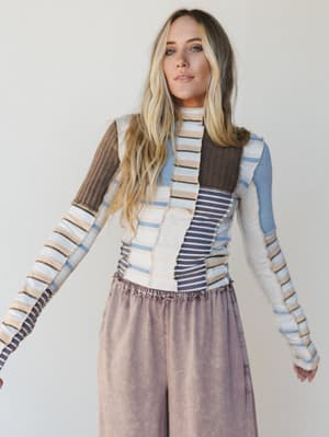 Woman wearing a patterned outfit with a plain background