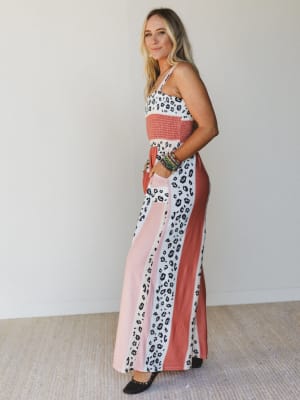 Woman wearing a colorful patterned dress with a white background