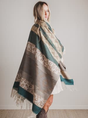 Woman wearing a patterned scarf with a neutral background
