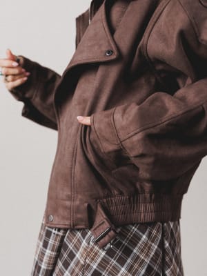 Brown jacket worn by a person on a plain background