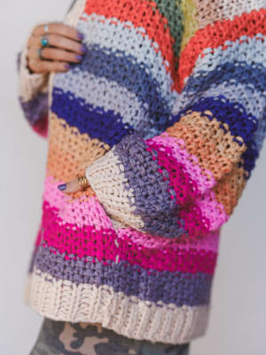 Colorful crocheted cardigan with a pattern of multicolored yarn.