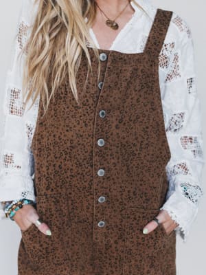 Brown leopard print dress over a white lace top with a plain background