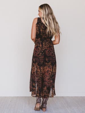 Woman wearing a floral dress with a plain background