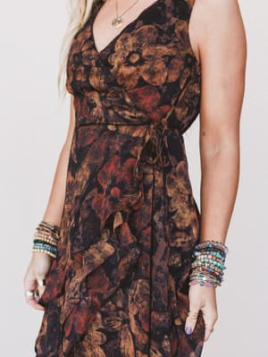 Woman wearing a floral dress with a plain background