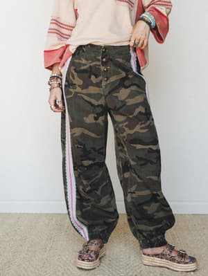 Wide-leg camo cargo pants with a boho-utility edge, styled with a blush embroidered top, stacked bracelets, and platform espadrille sandals — the kind of outfit that looks effortless but was absolutely thought about.