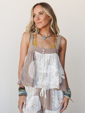 A patchwork woven tank top in a warm taupe stripe is layered with mixed lace and embroidered panels — the kind of top that looks like it was assembled from the prettiest vintage linens you've ever found, styled here with matching bottoms, stacked bea