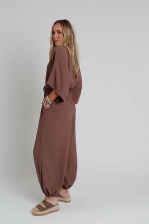 side view of The Nest New Love Relaxed Drawstring Jumpsuit in Mocha from Three Bird Nest