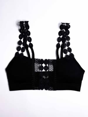 The Imagine That Bralette - Black features decorative lace and circular cut-out patterns on the straps and front panel, shown flat against a white background.
