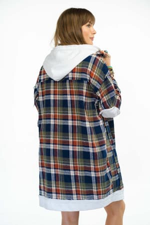 A woman with light brown hair is seen from behind wearing the Flannel Layers Hooded Jacket in Navy Multi, featuring an oversized fit, blue, green, and red plaid pattern, and a white hood, against a white background.