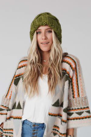 Person wearing a green knit beanie.