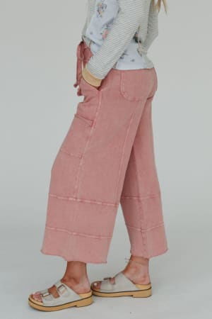 Wearing the Lucky One Wide Leg Pant in mauve, paired with a striped floral top and beige wooden-sole sandals, this look captures effortless boho style against a simple light background.