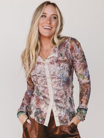 Woman wearing a floral blouse with a plain background
